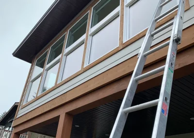 Early Bird Cleaning setting up a ladder to wash windows
